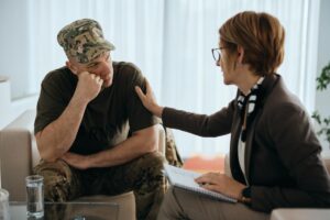 Woman comforts vet by putting hand on him as he discusses alcohol abuse in the military
