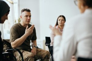 Man talks in group therapy about his drug use in the military