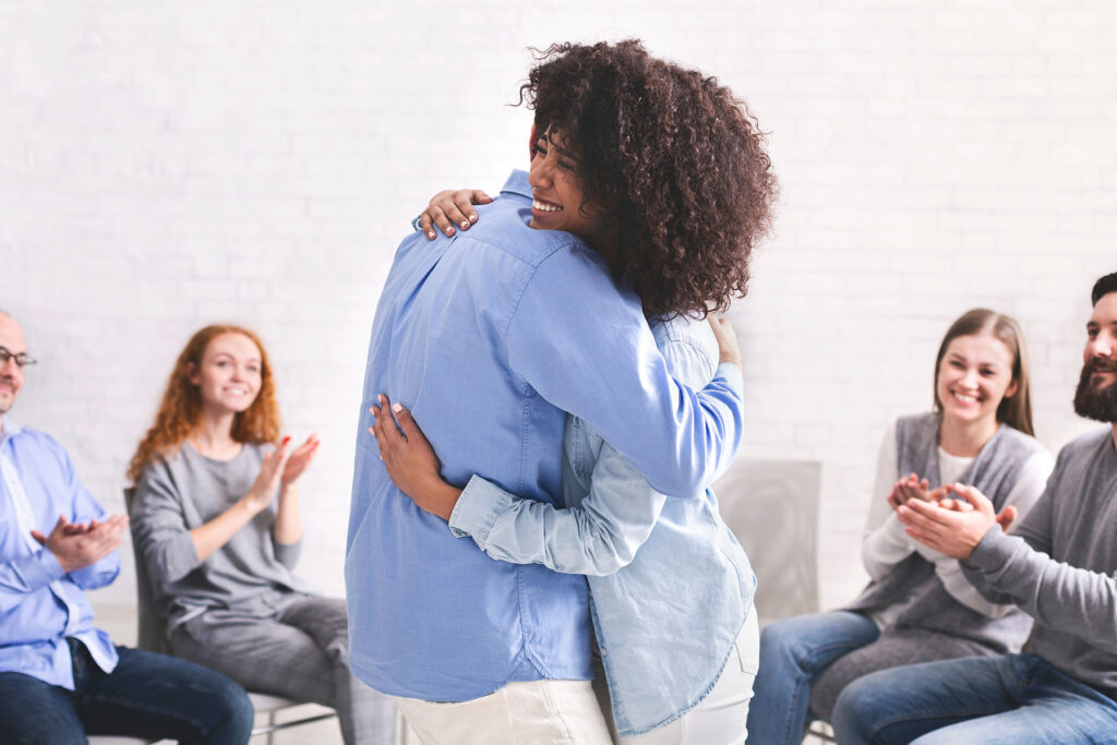 Folks hug while in an outpatient rehab in mississippi