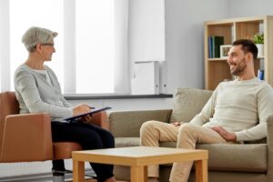Therapist talks to patient during inpatient rehab in Mississippi